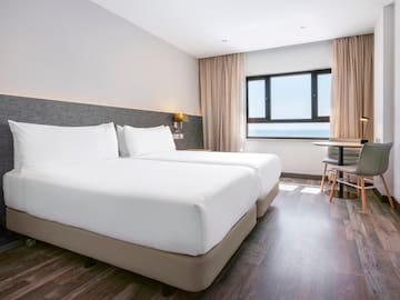 a room with two beds and a table