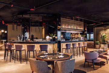 a restaurant with a bar and chairs