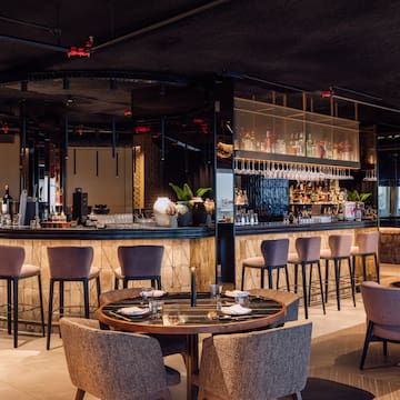 a restaurant with a bar and chairs