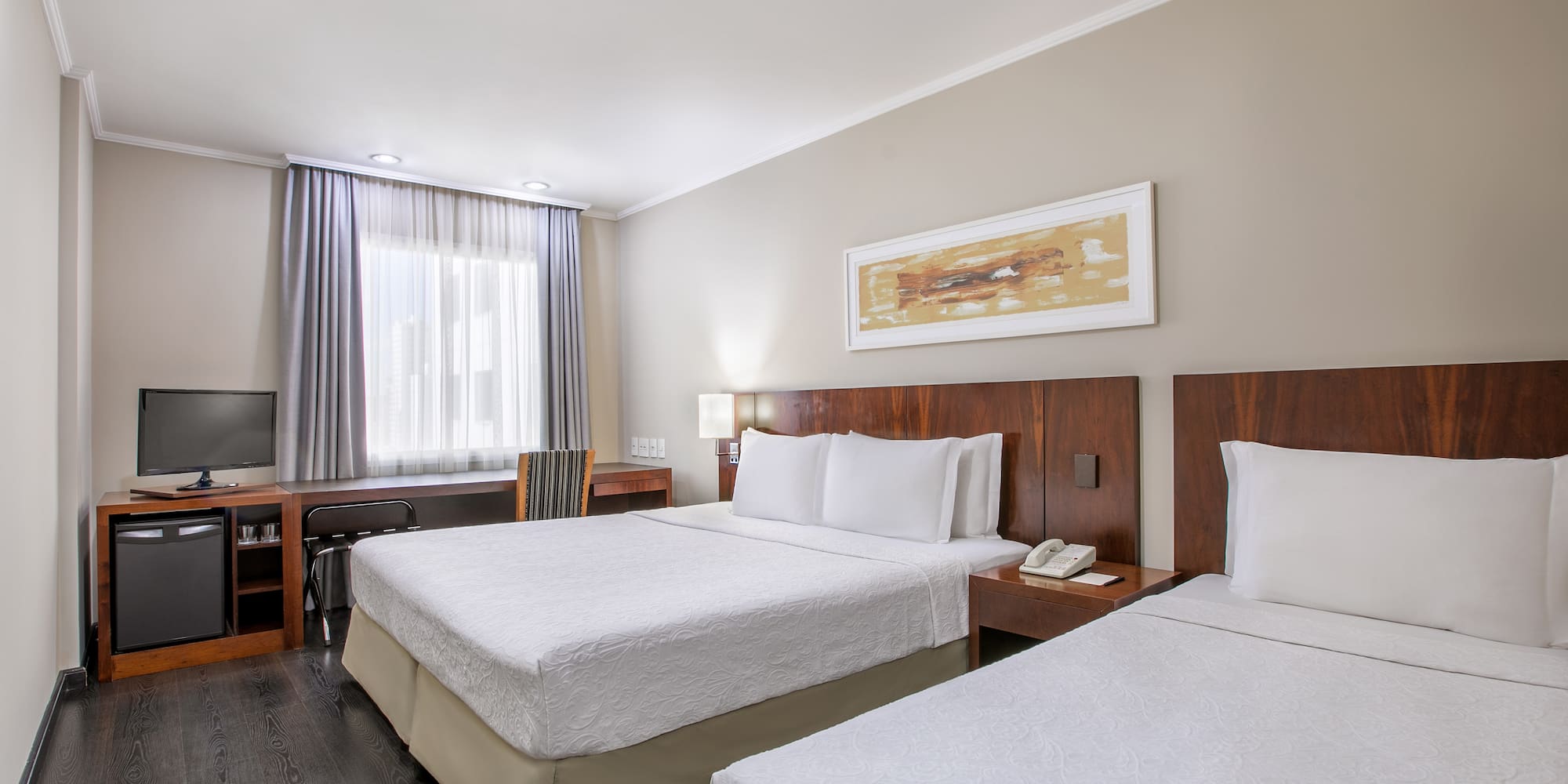 a room with two beds and a television