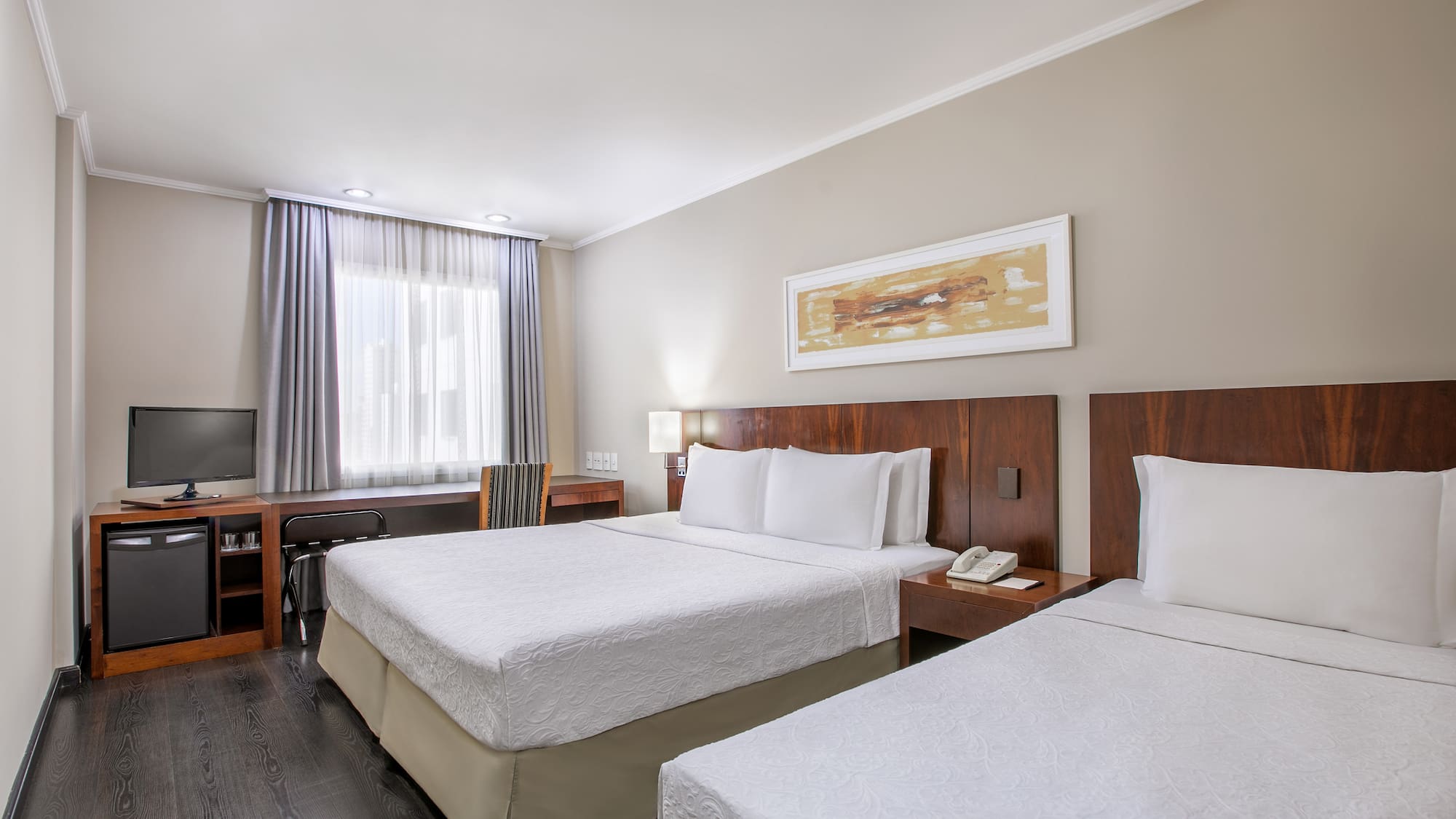 a room with two beds and a television