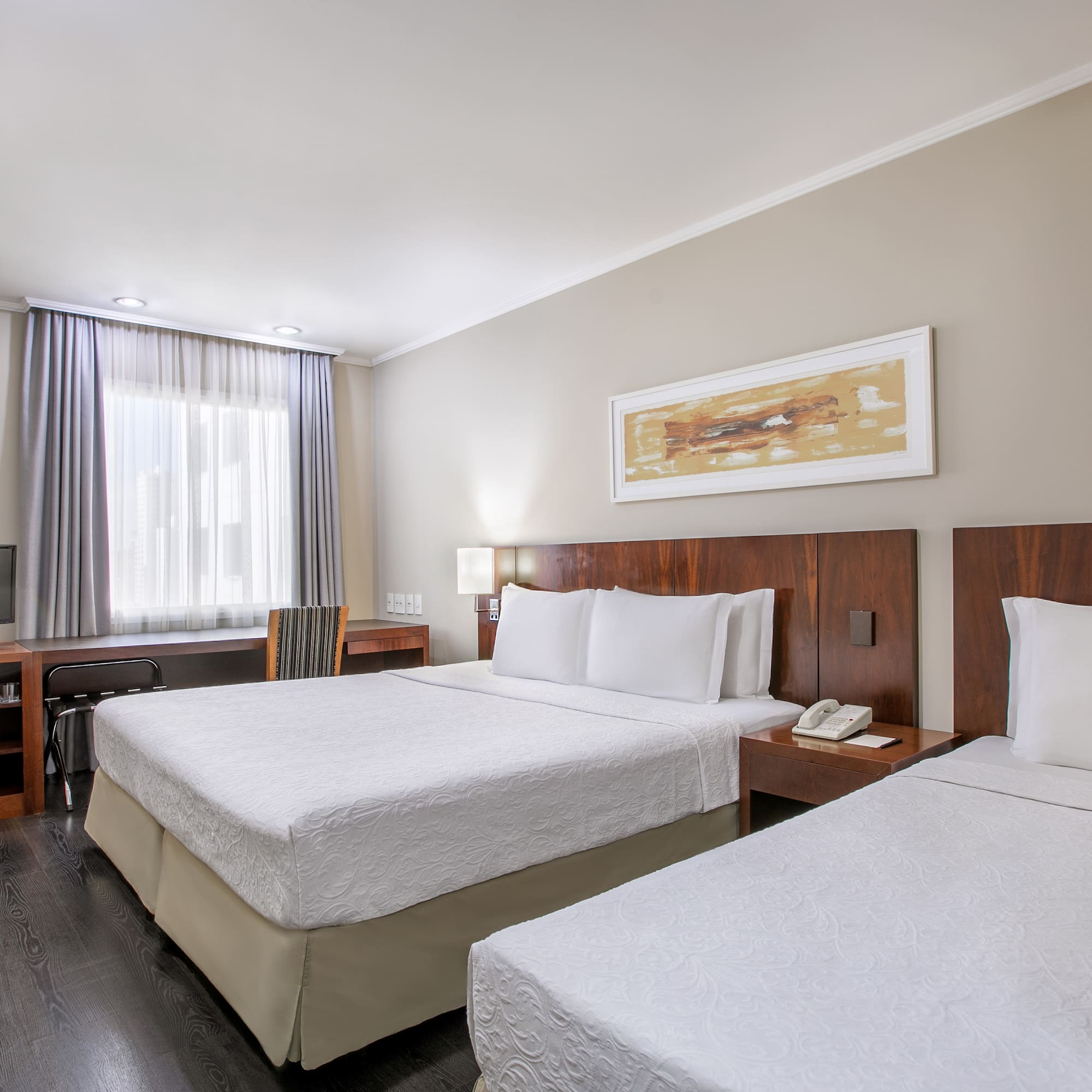 a room with two beds and a television