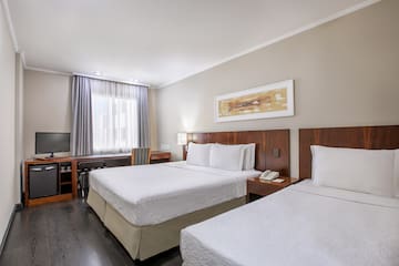 a room with two beds and a television