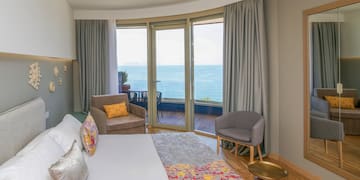 a room with a large window overlooking the ocean