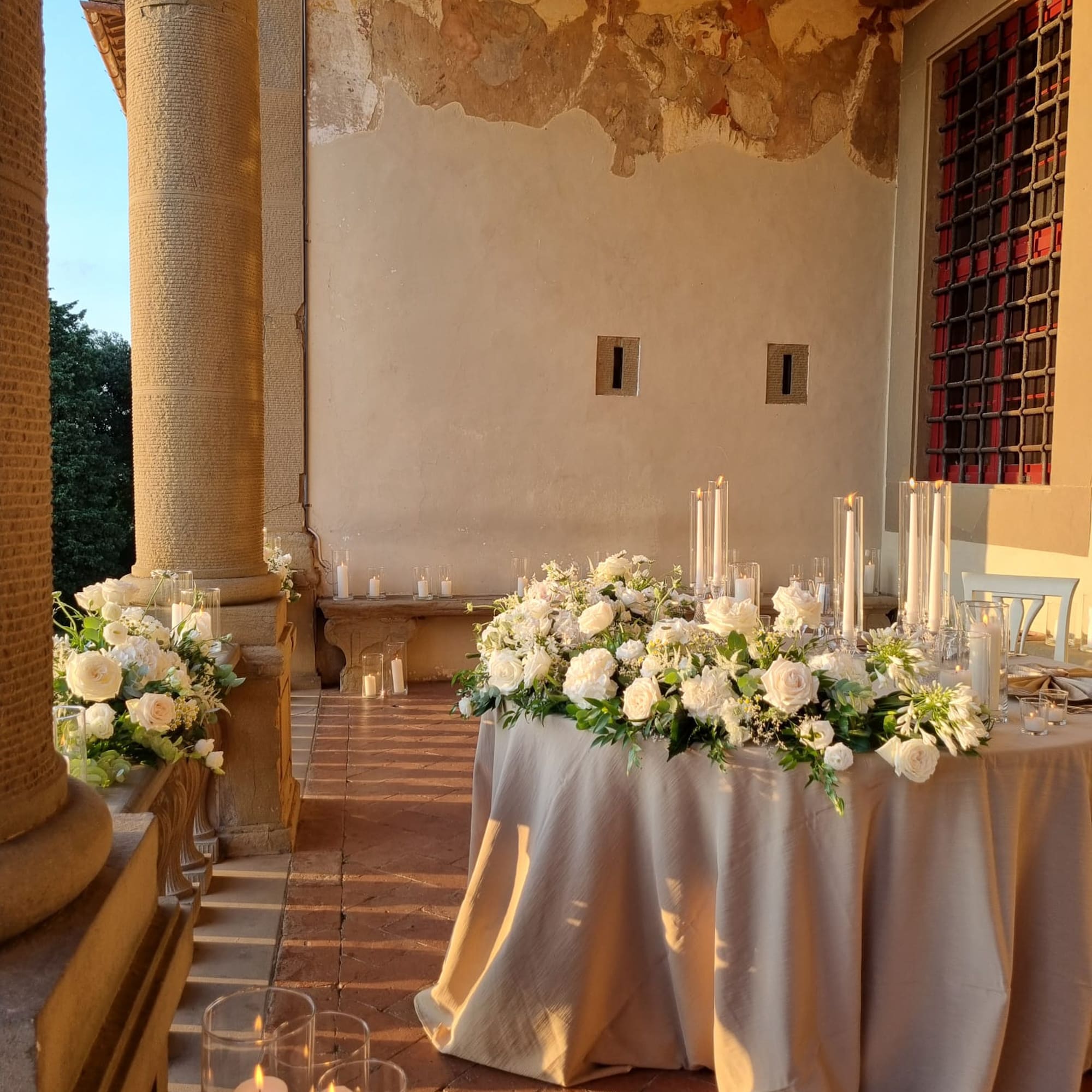 a table with flowers and candles on it
