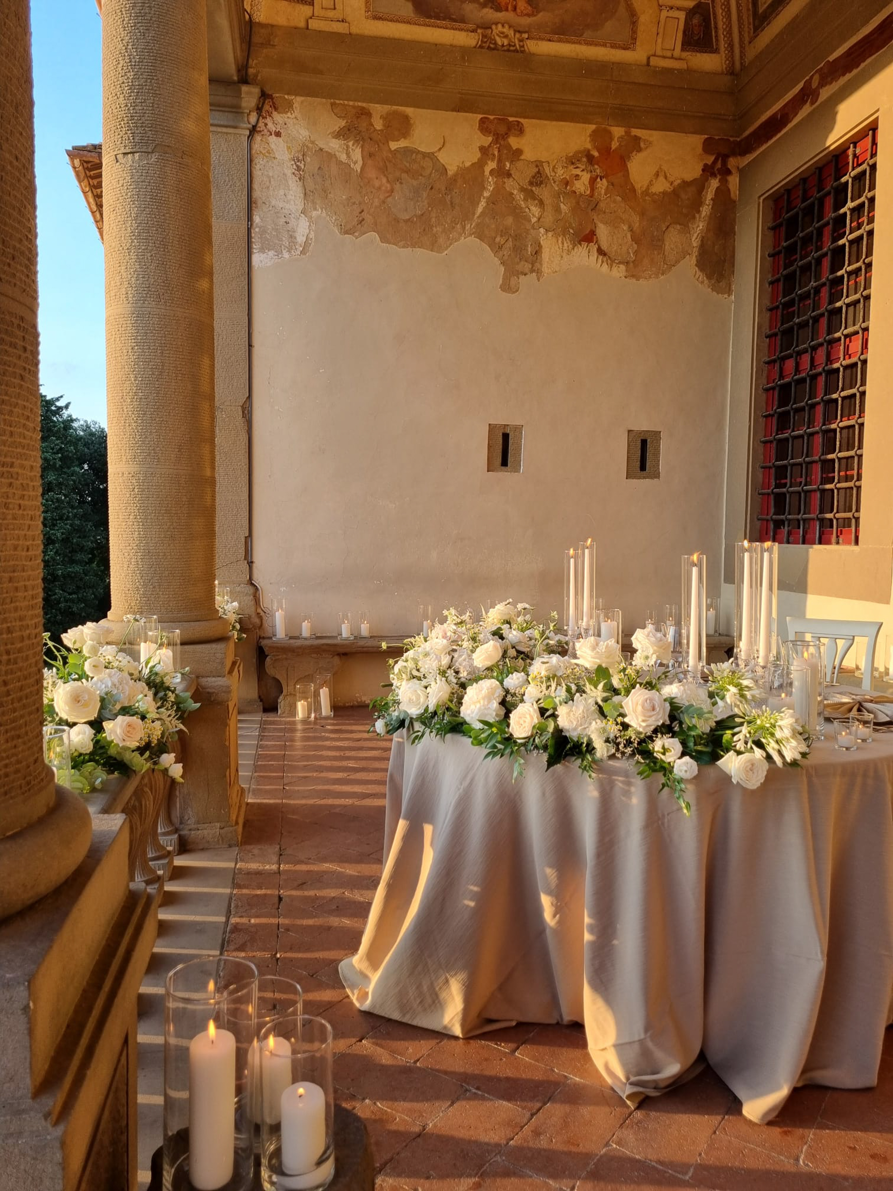 a table with flowers and candles on it