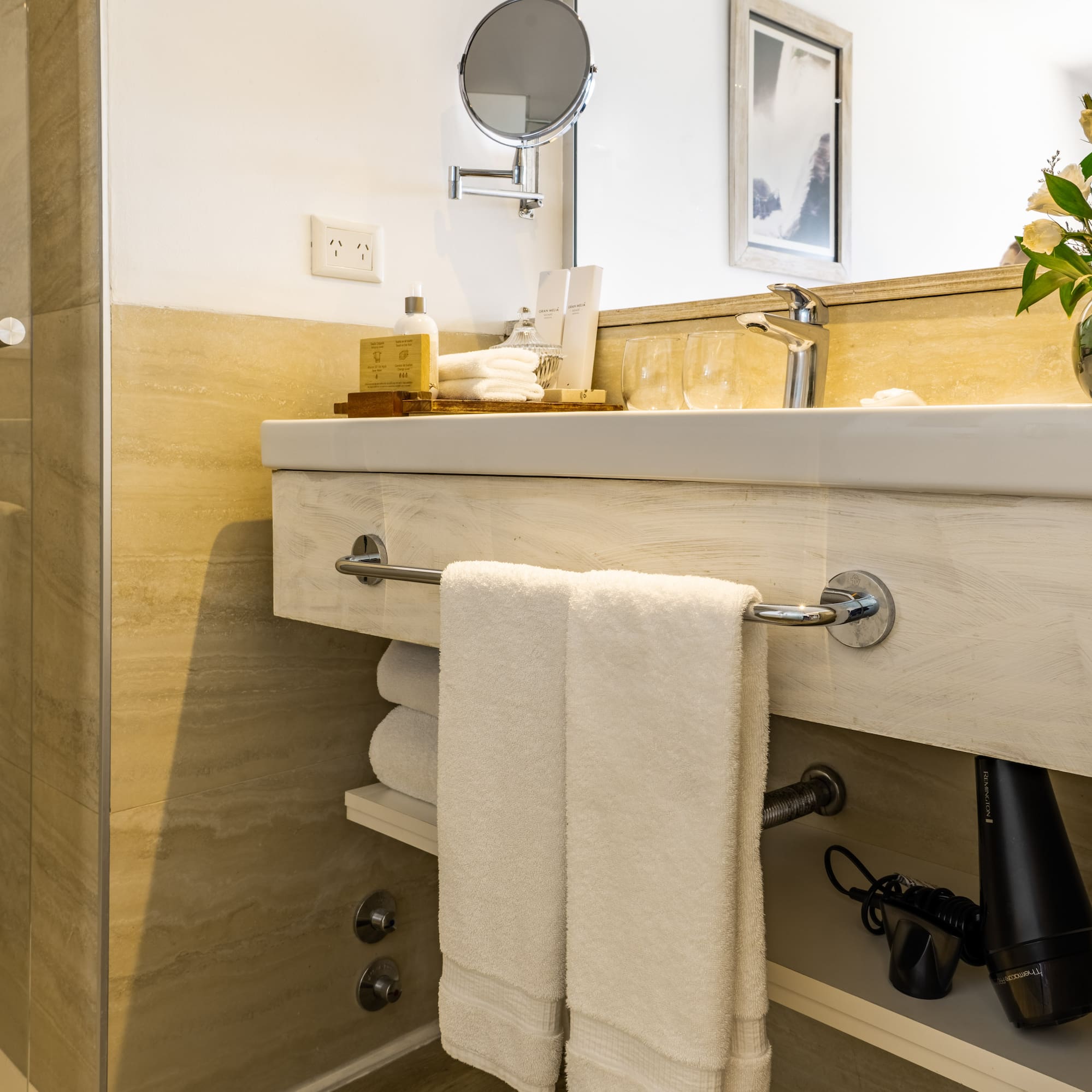 a bathroom with a mirror and towels