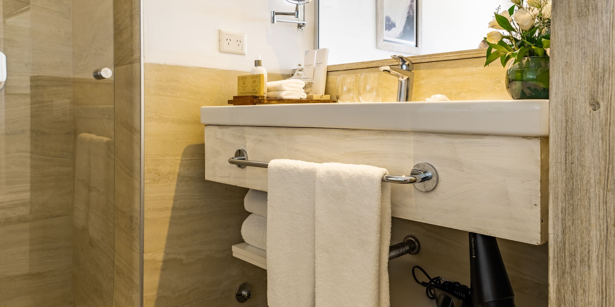 a bathroom with a mirror and towels