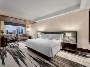 a room with a bed and a desk and chair