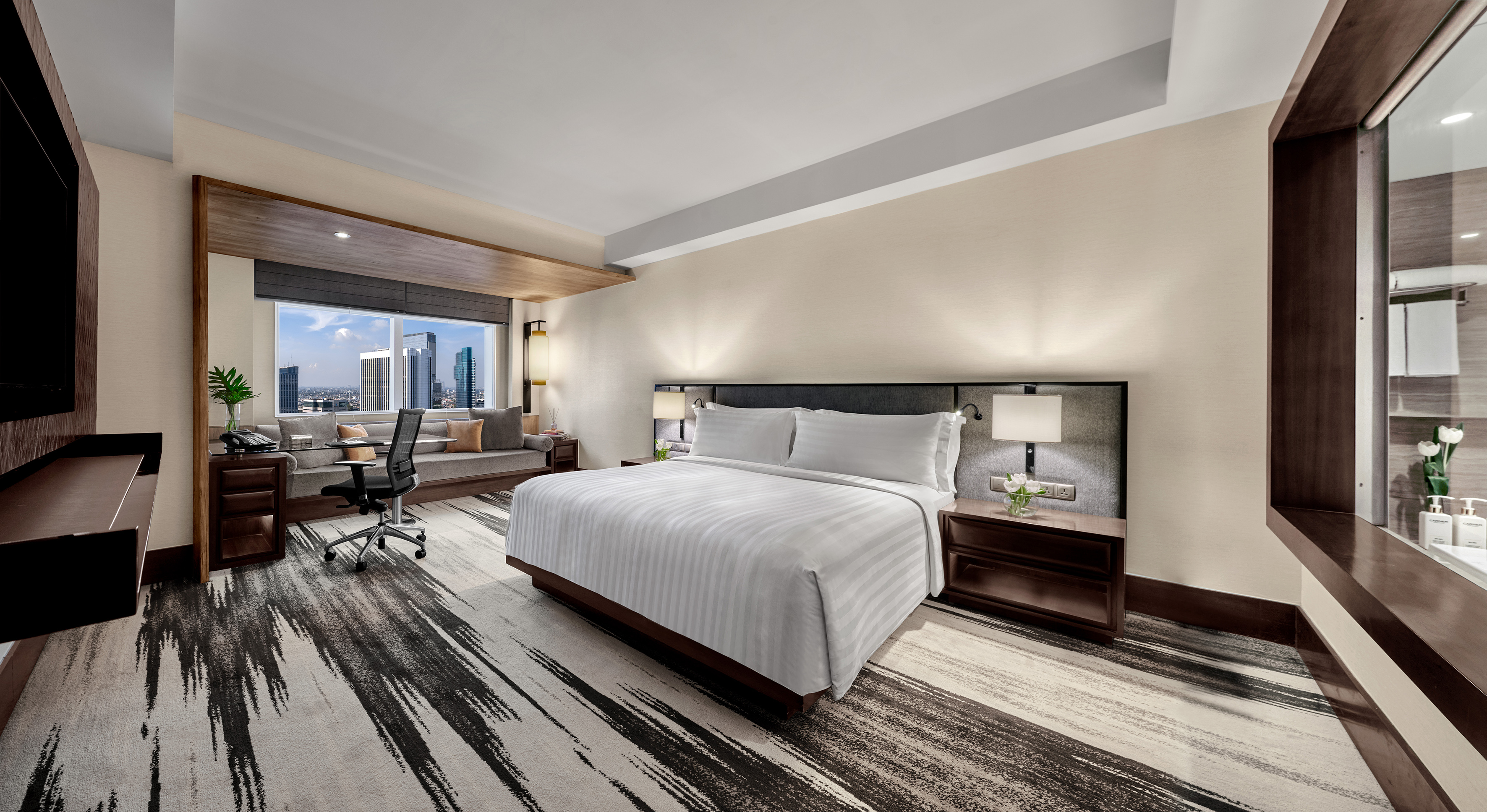 a room with a bed and a desk and chair