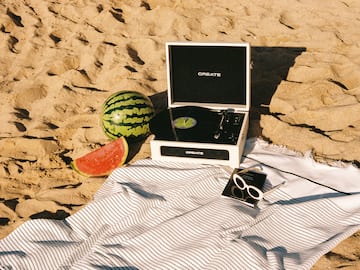 a record player and watermelon on a beach
