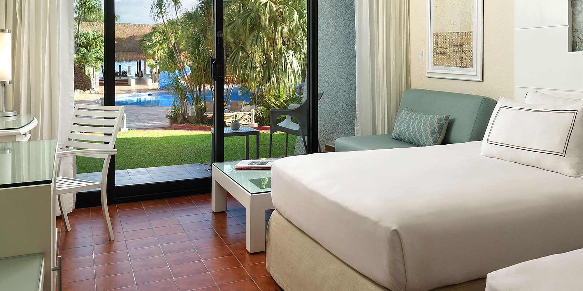 a room with two beds and a glass door