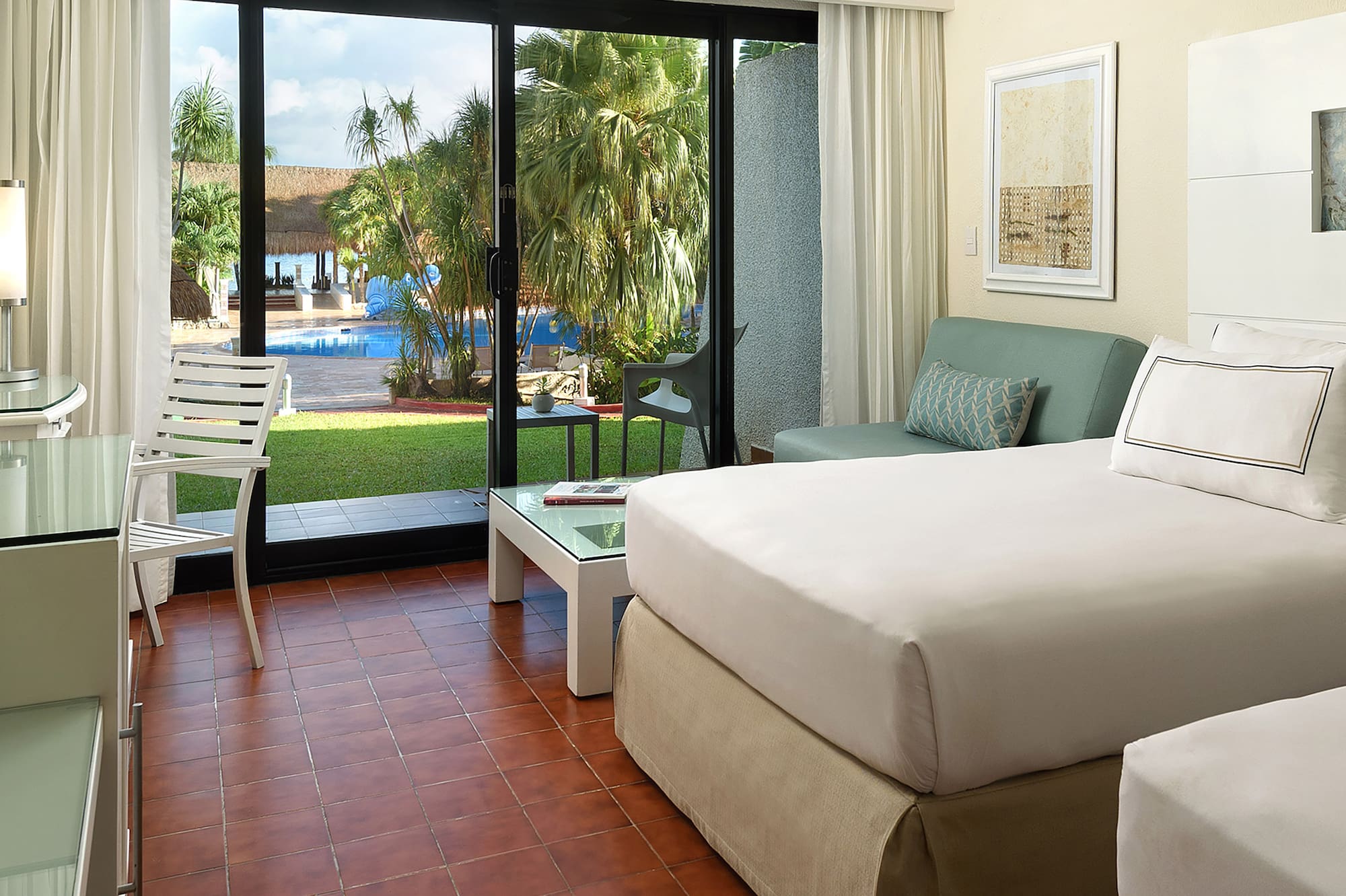 a room with two beds and a glass door