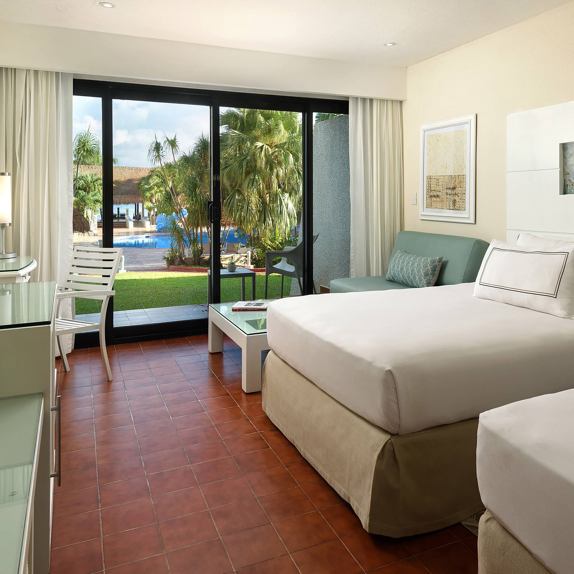 a room with two beds and a glass door