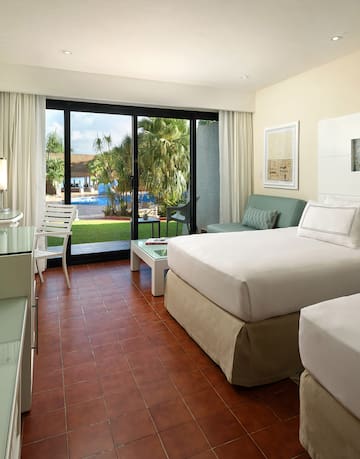 a room with two beds and a glass door