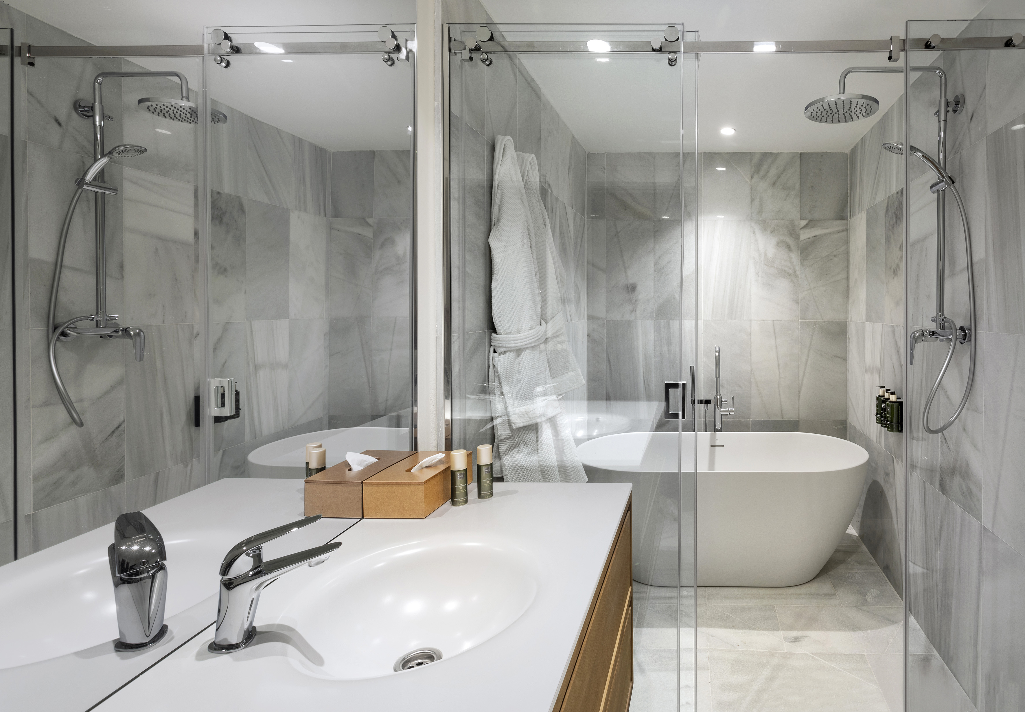 Luxury marble bathroom with rain shower, freestanding bathtub, and modern vanity.