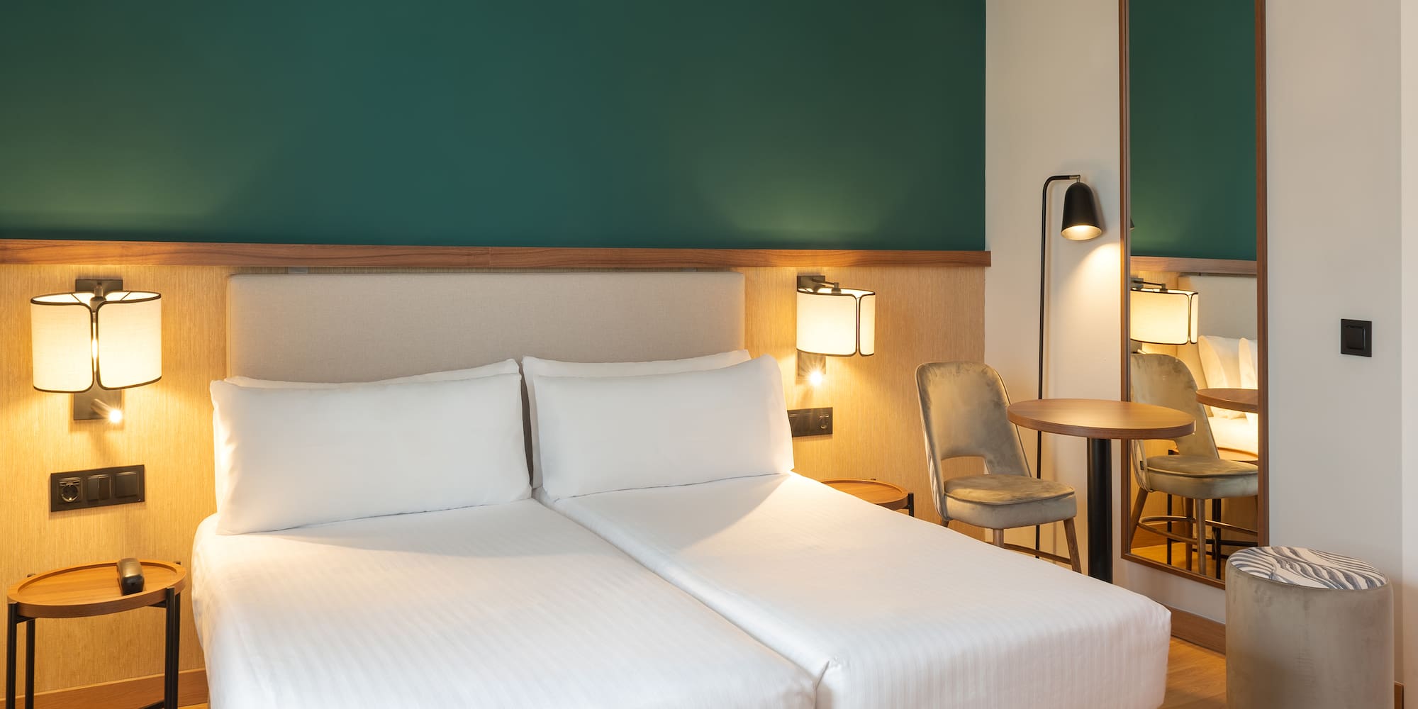 a hotel room with two beds and a table