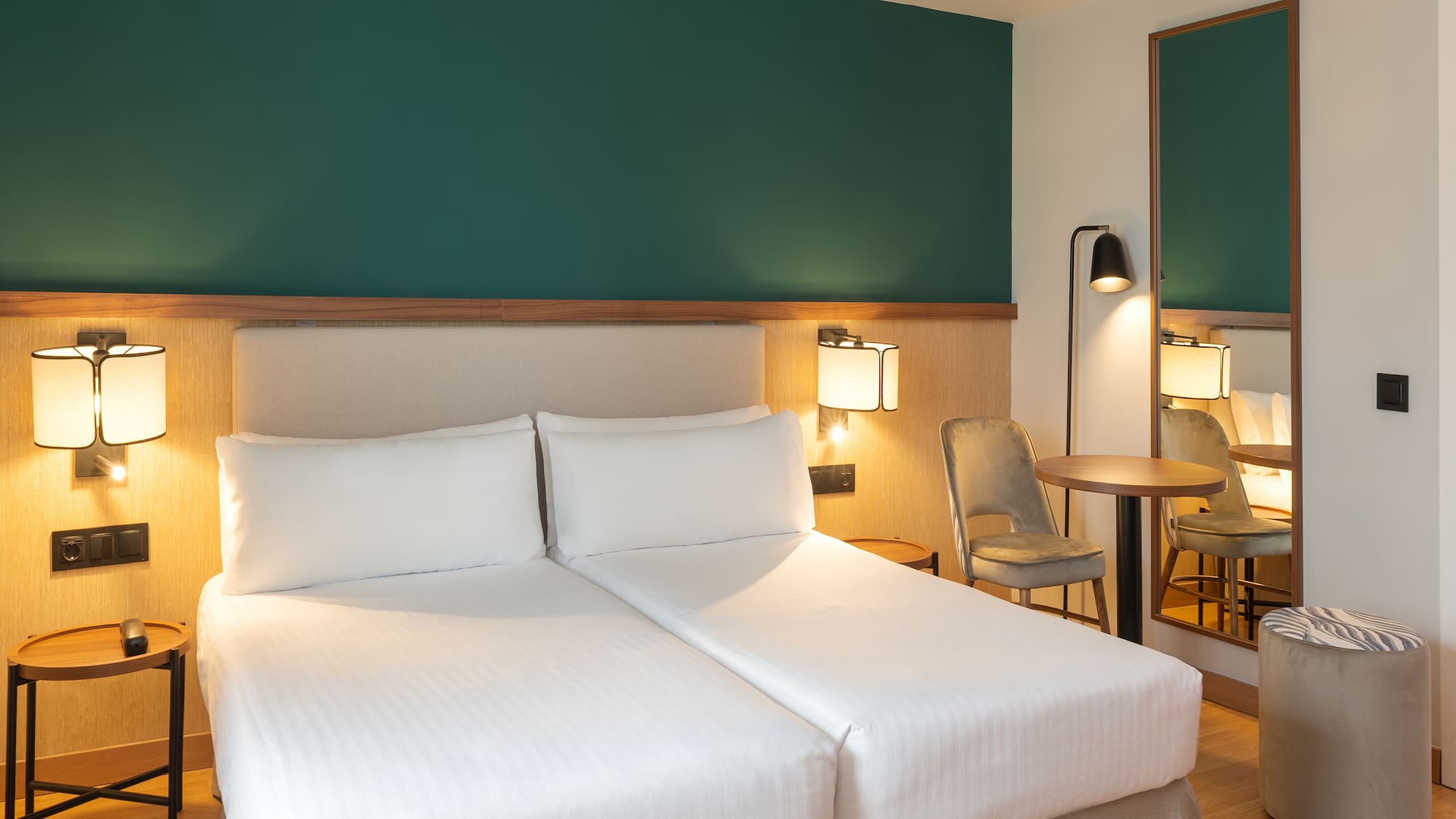 a hotel room with two beds and a table