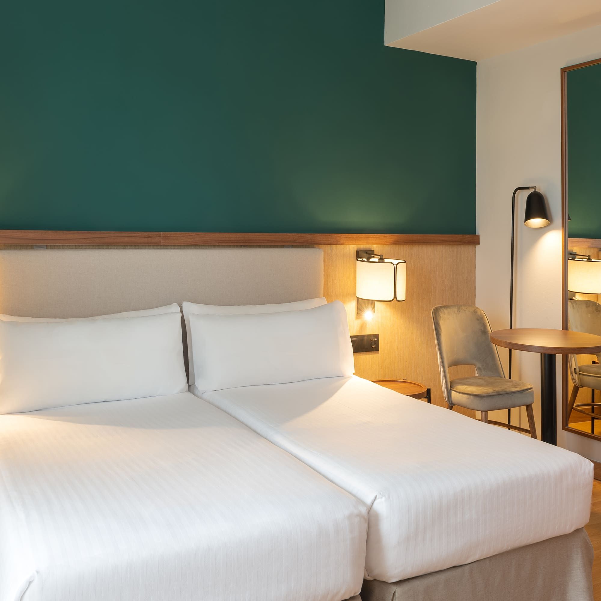 a hotel room with two beds and a table