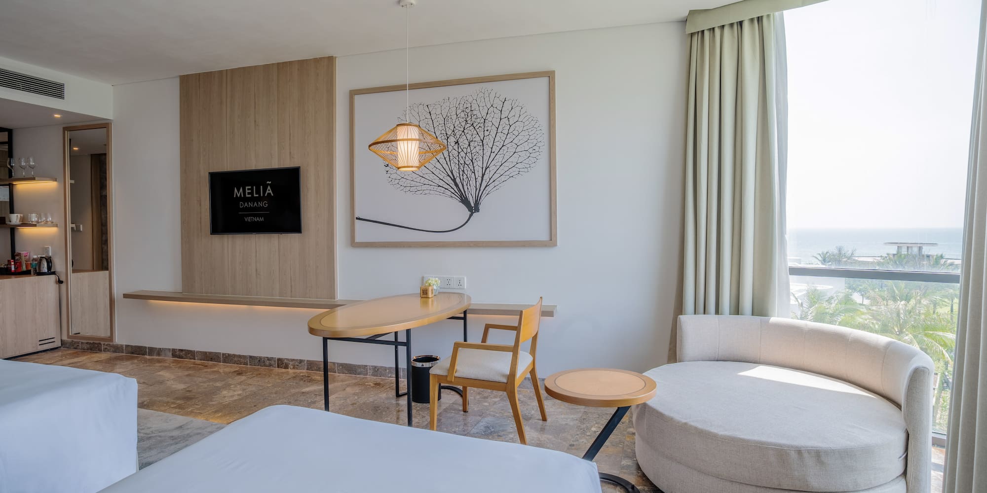 a room with a bed and a table and chairs