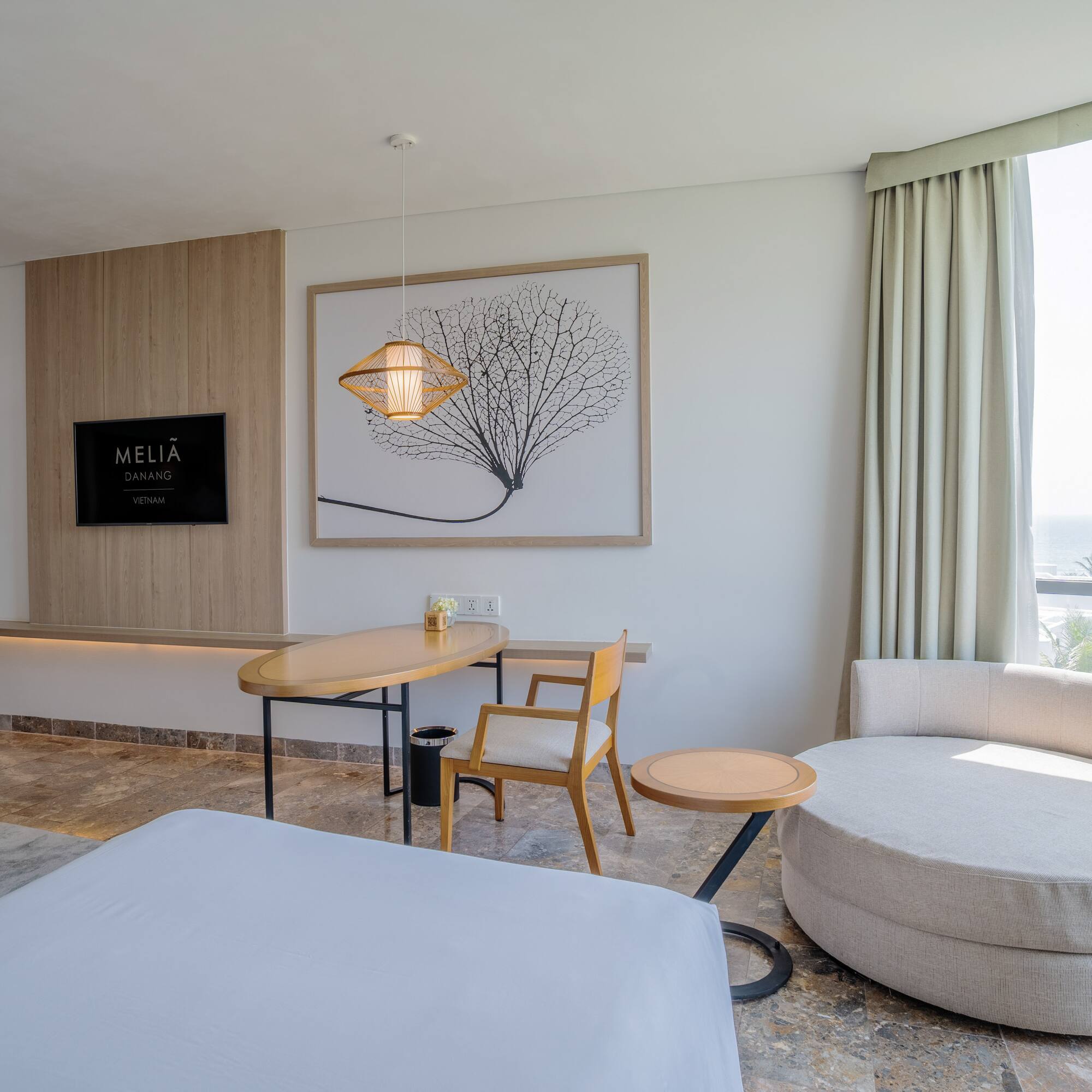 a room with a bed and a table and chairs