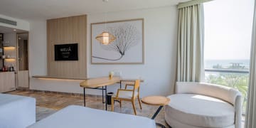 a room with a bed and a table and chairs