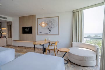 a room with a bed and a table and chairs