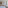 a room with a bed and a table and chairs