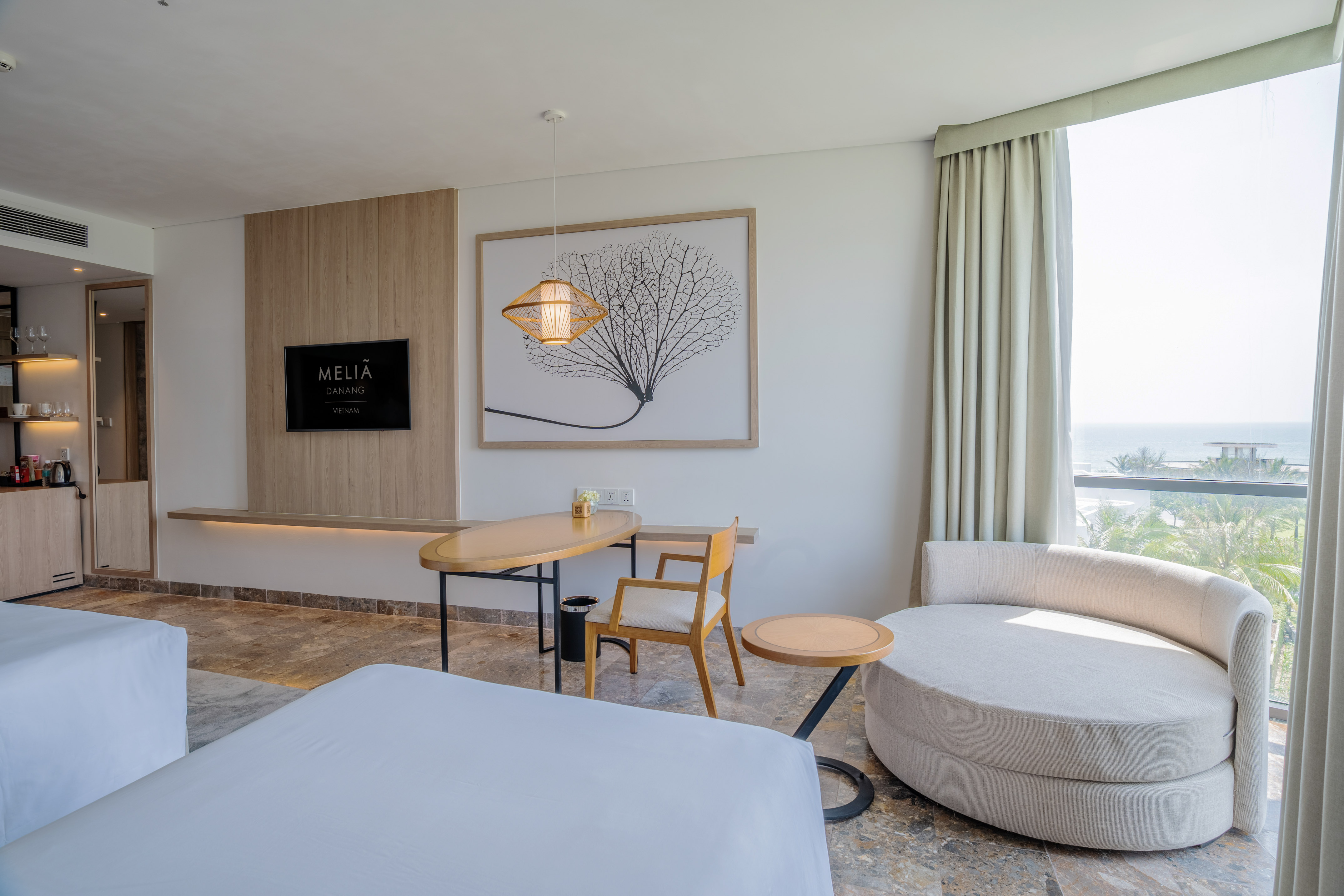 a room with a bed and a table and chairs