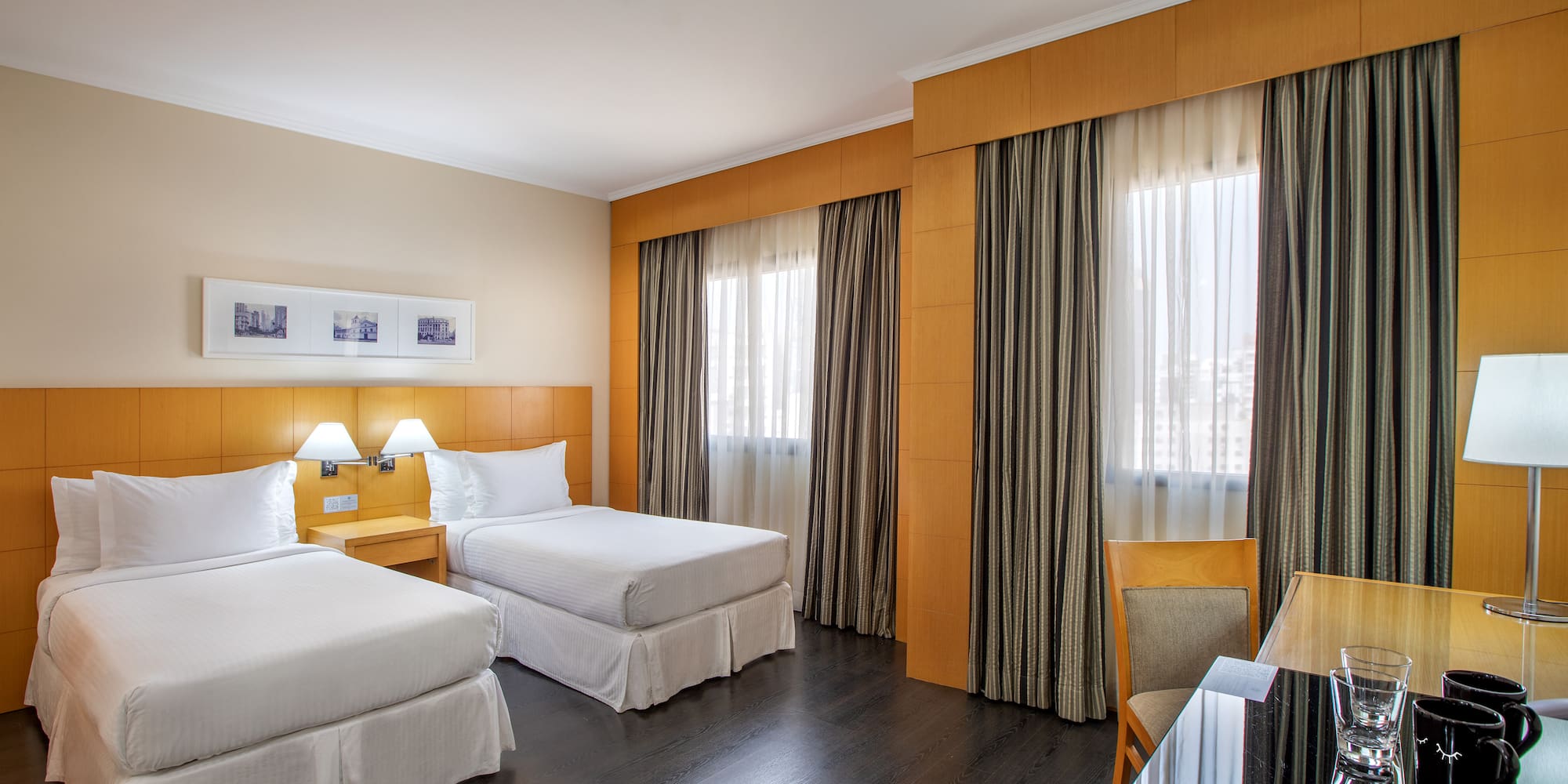 a room with two beds and a table