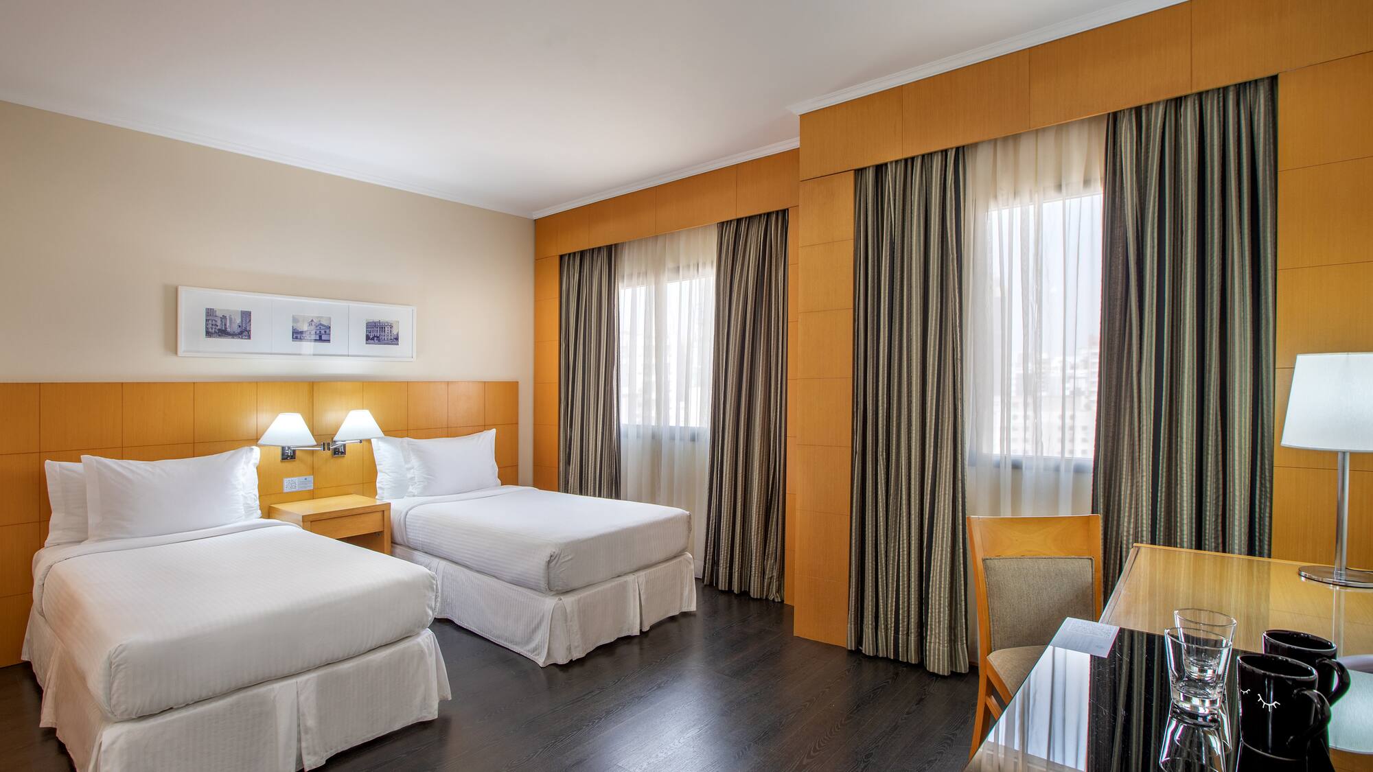 a room with two beds and a table