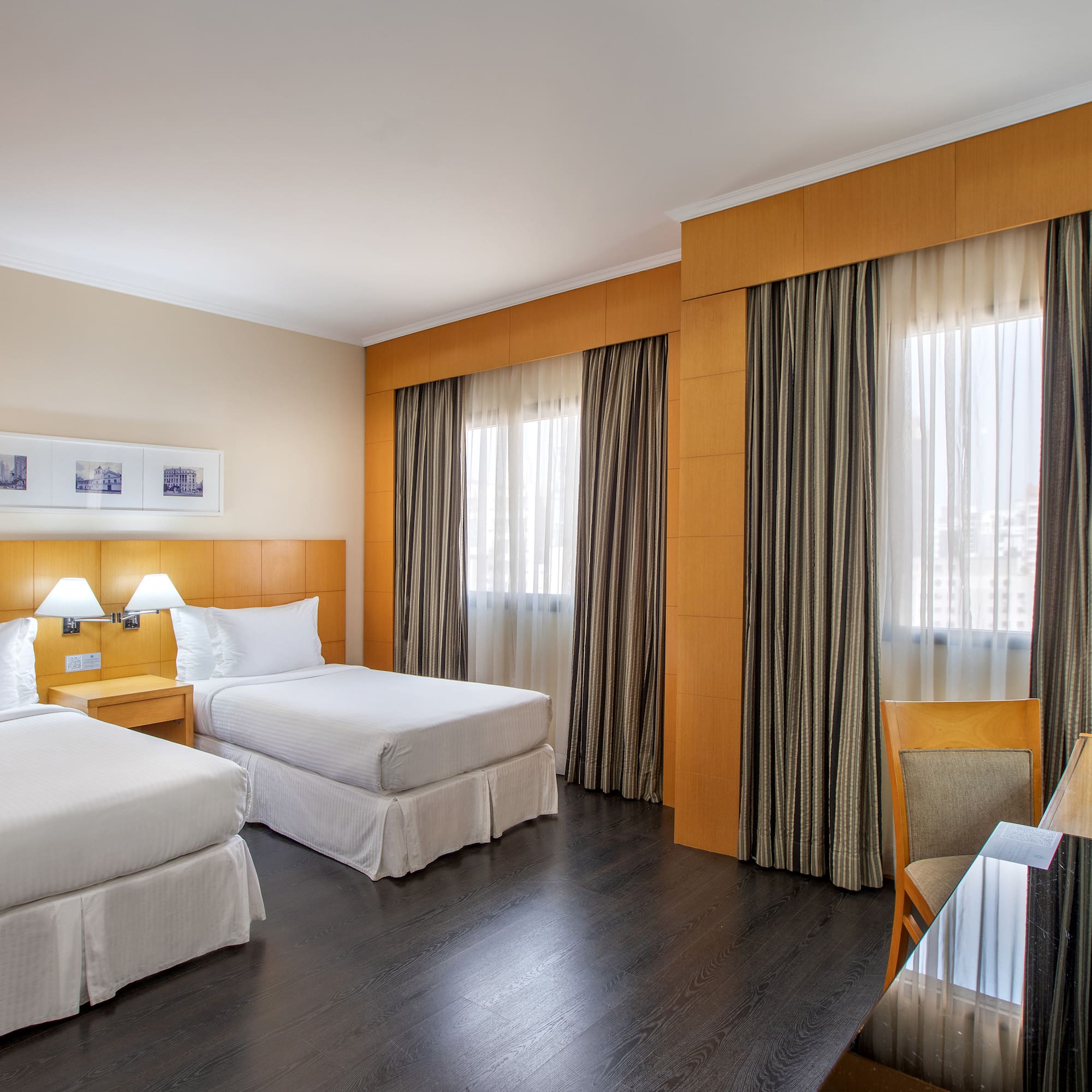 a room with two beds and a table