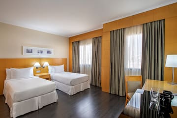 a room with two beds and a table