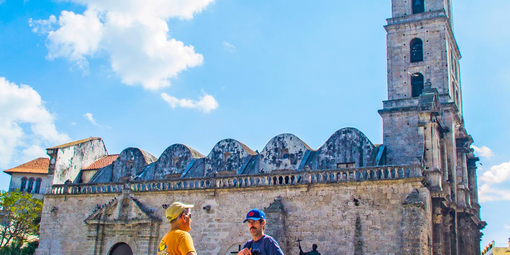 a group of people in front of a stone building