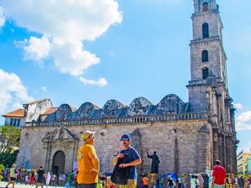 a group of people in front of a stone building