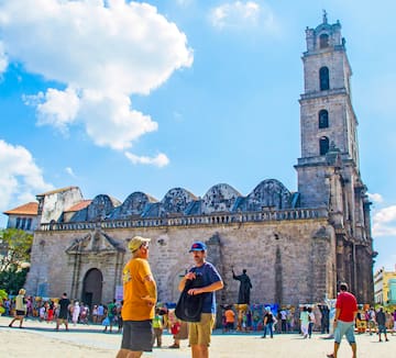 a group of people in front of a stone building