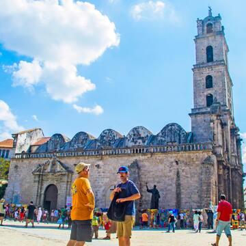 a group of people in front of a stone building