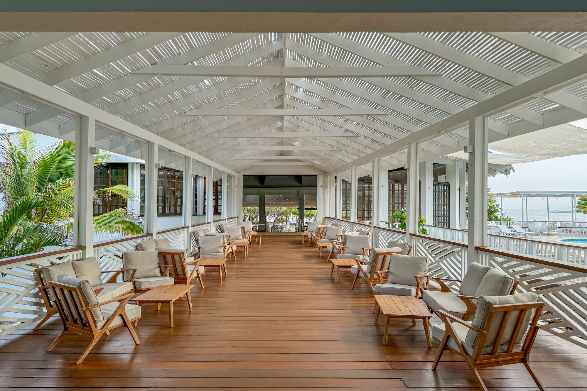 a large covered porch with chairs and tables