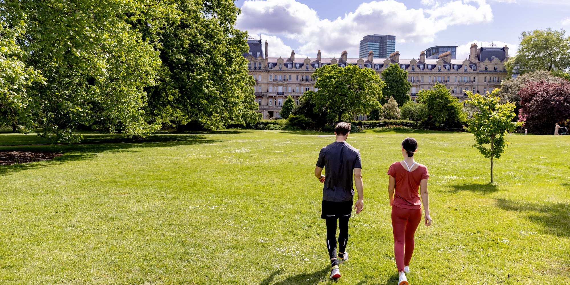 a man and woman walking in a park