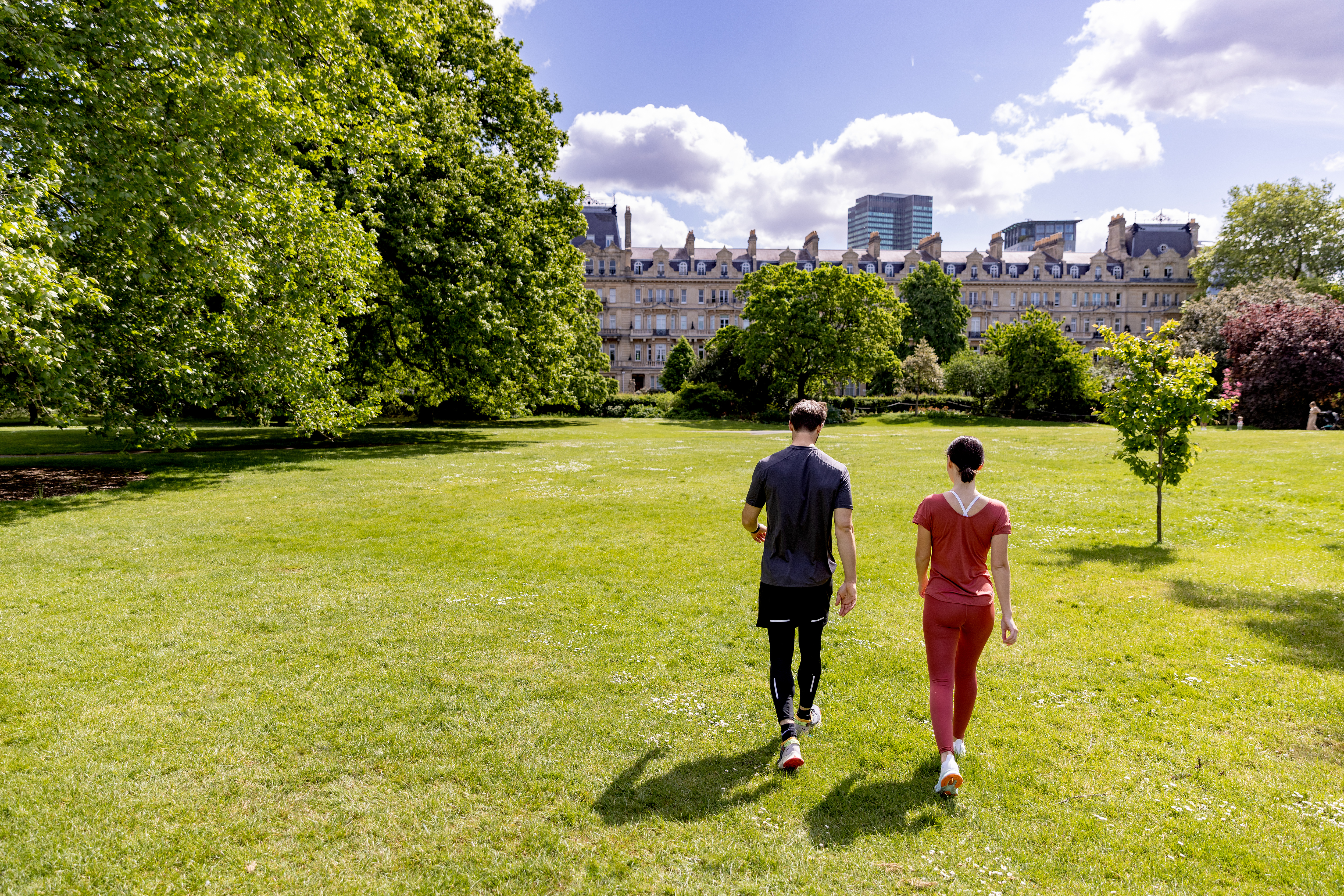 a man and woman walking in a park