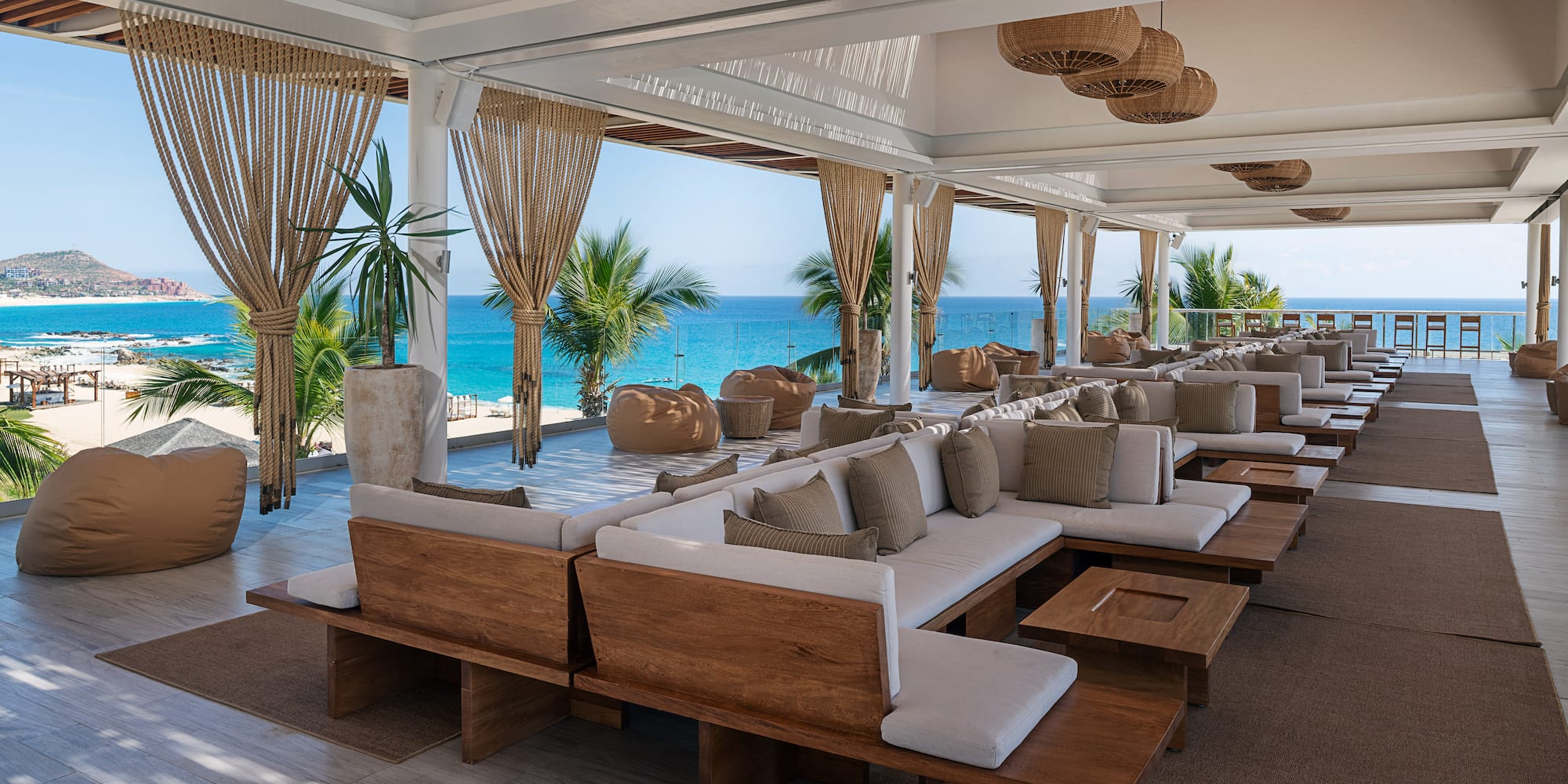 a large room with white couches and tables and chairs