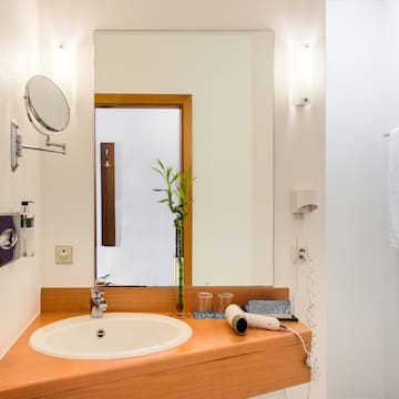 a bathroom with a mirror and a sink