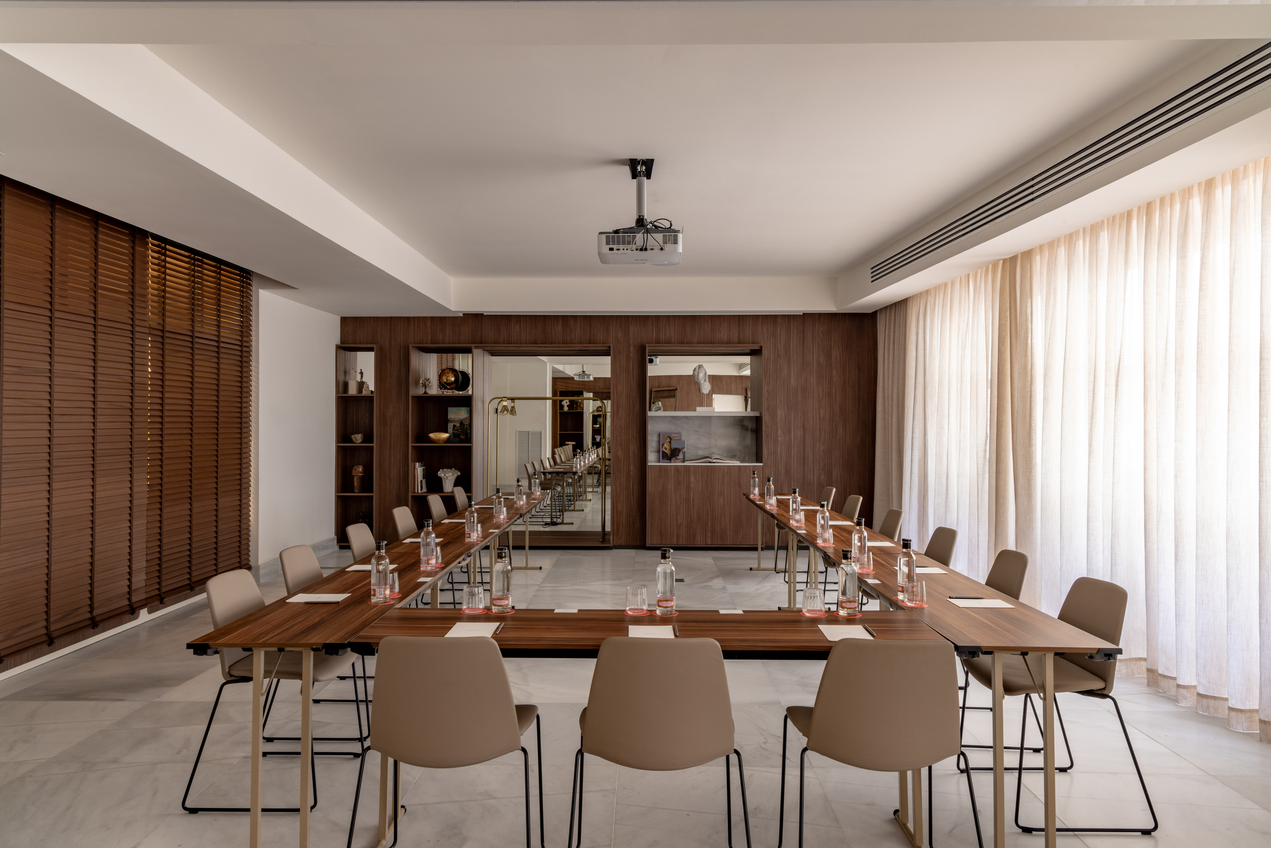 a room with long tables and chairs