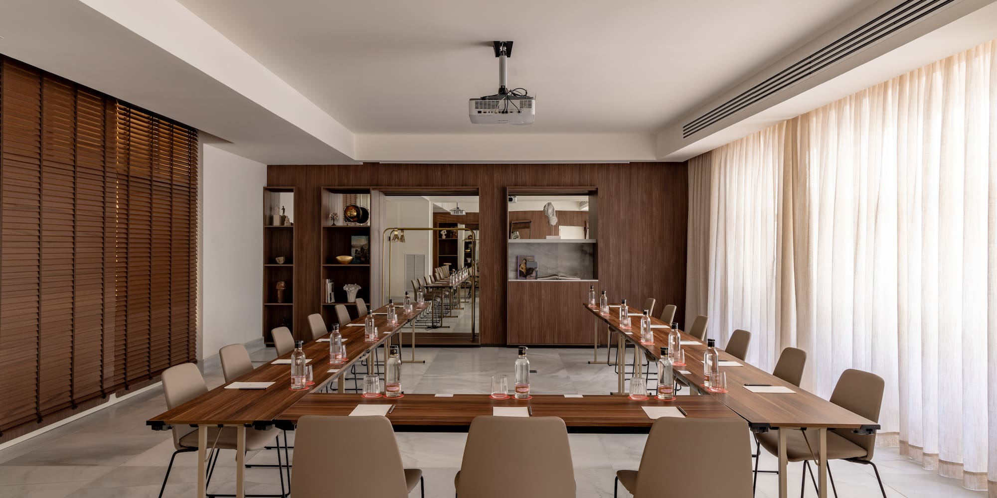 a room with long tables and chairs