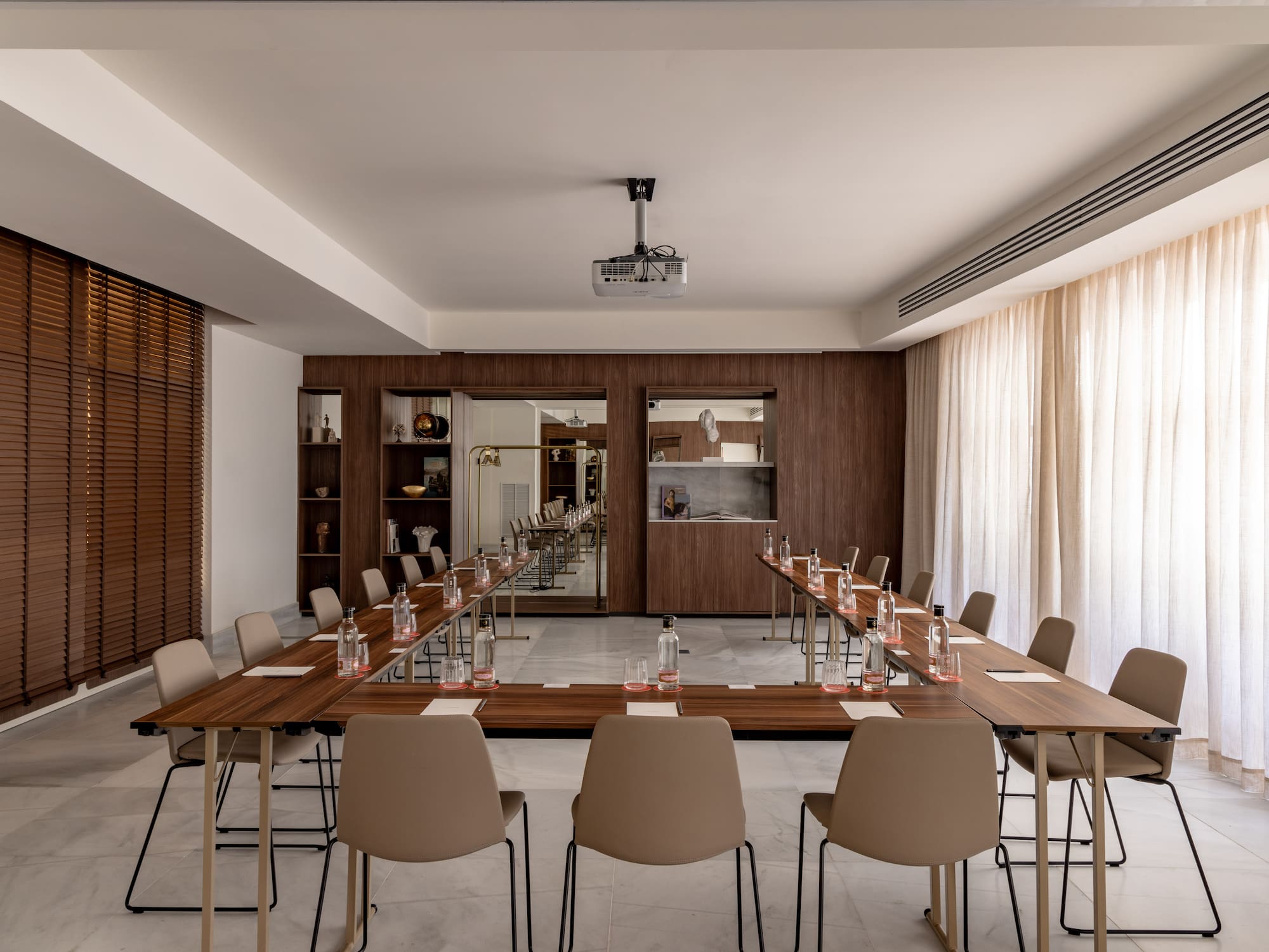 a room with long tables and chairs