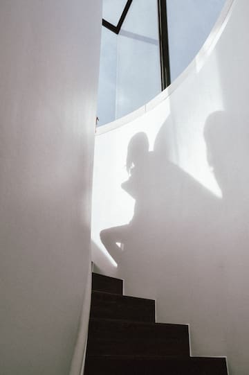 a shadow of a person on a staircase