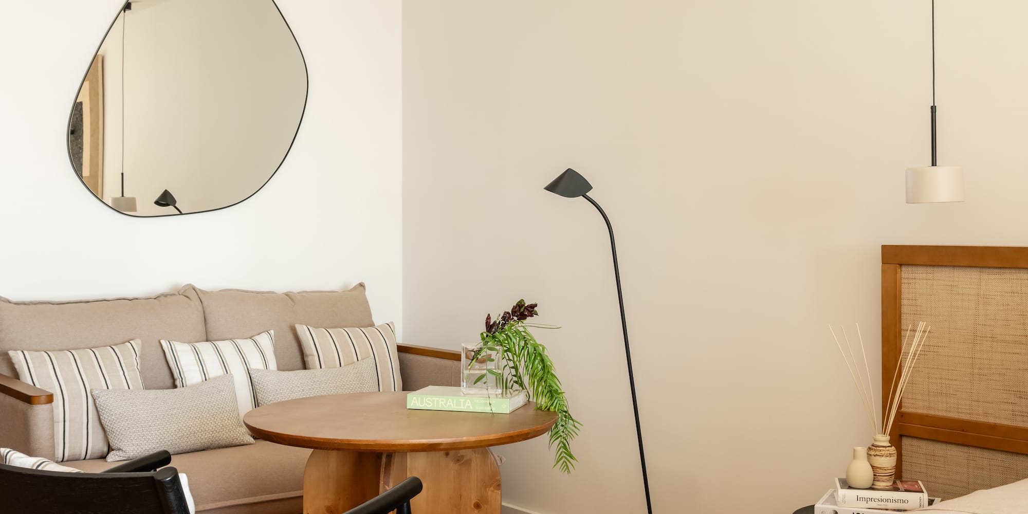 a room with a couch and a round mirror