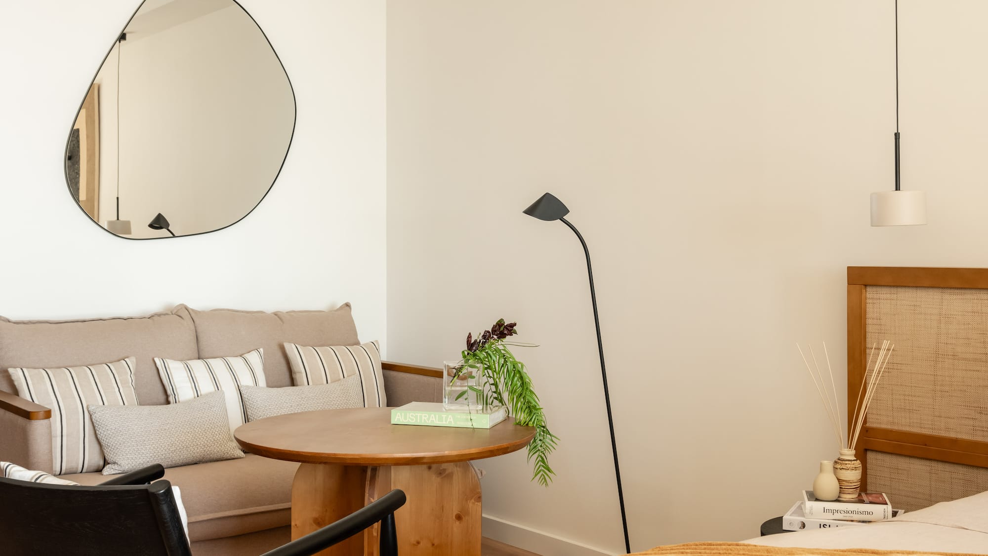 a room with a couch and a round mirror