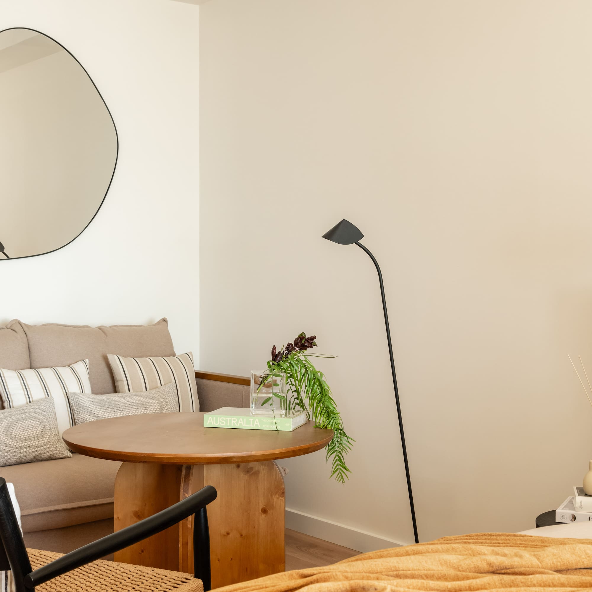 a room with a couch and a round mirror