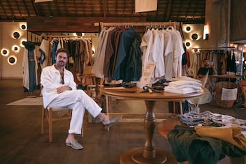 a man sitting at a table in a clothing store